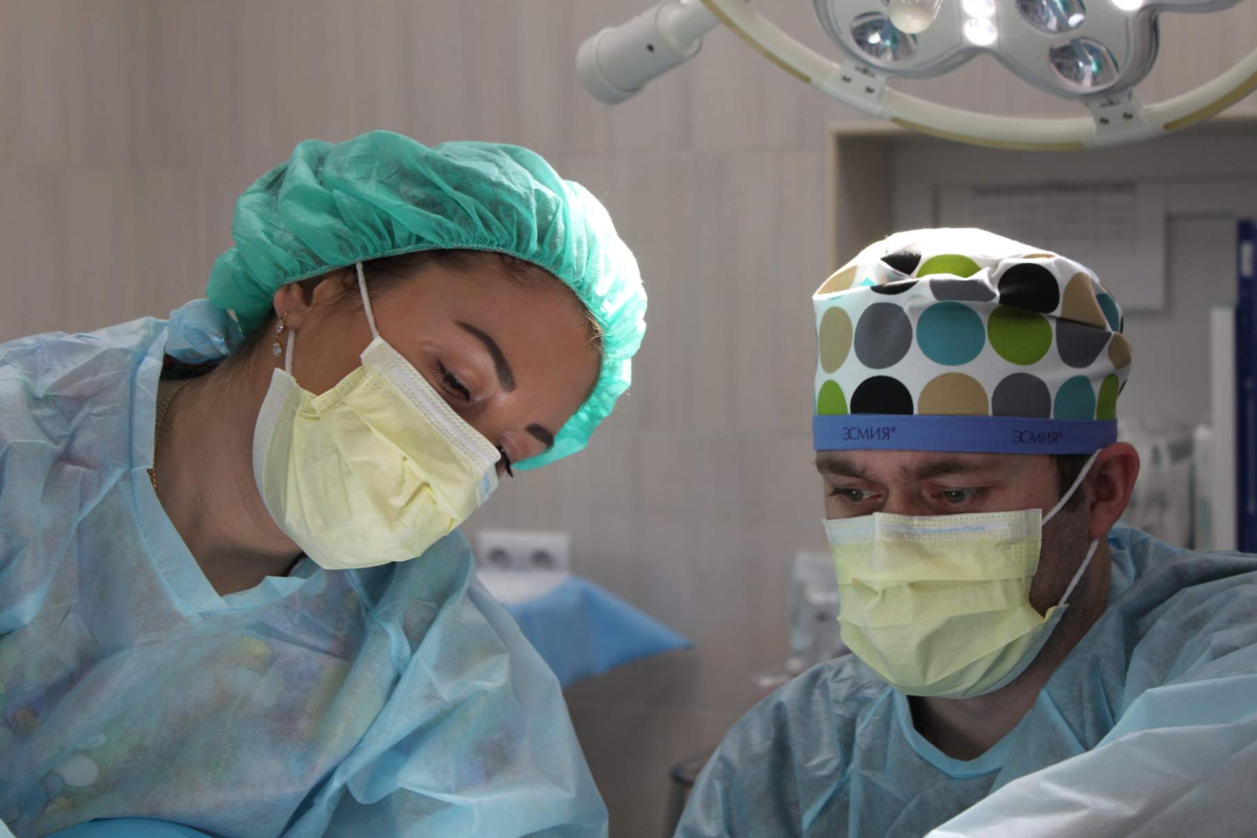 Two surgeons focusing on the patient during a procedure